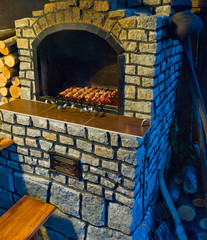 Stone oven with kebabs.