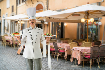 Elegant chef cook with a nameplate for text in hands on a white background