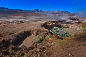 Boiling red mud pools in the geothermal area Sol de Manana in western Bolivia near Uyuni at an elevation of 15,900 feet resembling a landscape on planet mars.