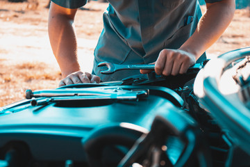 Machanic holding wrench in the repair garage,Car maintenance concept