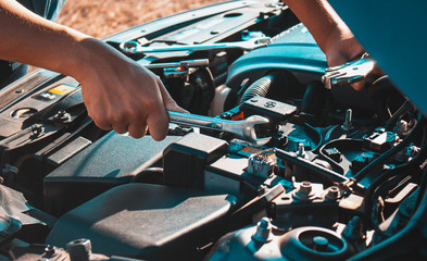 Machanic holding wrench in the repair garage,Car maintenance concept