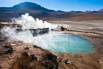 Boiling red mud pools in the geothermal area Sol de Manana in western Bolivia near Uyuni at an elevation of 15,900 feet resembling a landscape on planet mars.
