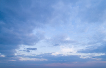 Naklejka na ściany i meble Beautiful sky with stretched clouds during twilight.