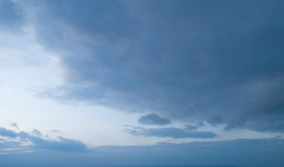 Beautiful sky with stretched clouds during twilight.