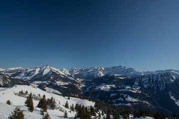 Beautiful mountain panorama from Leysin range on a cloudy winter day. Looking towards Les Diablerets ski centre and valley below.