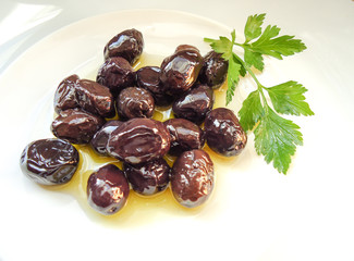 olives in the plate with okive oil and parsley