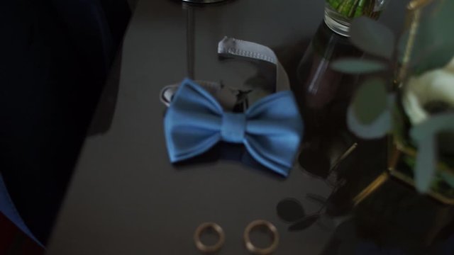 bow tie with wedding rings on the table
