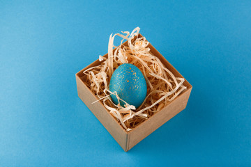 Easter egg painted blue with gold.