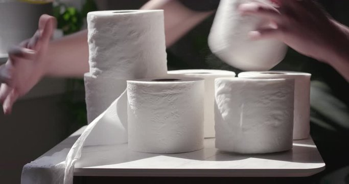 A man steals rolls of toilet paper during the COVID-19 coronavirus quarantine social distancing experience in March 2020 due to price gouging and profiteering.