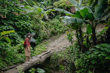 woman crossing bridge in jungle