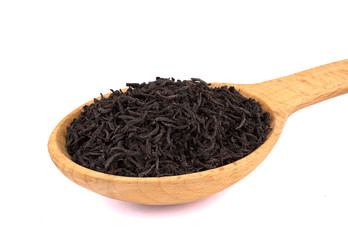 Dry tea in a wooden spoon, isolated on white background, delicious, natural