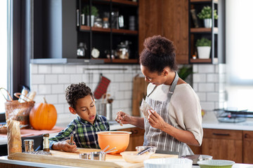 Mother with his son prepare pie in the kitchen