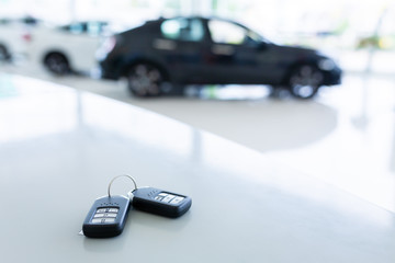 New key in car showrooms with two new remote keys placed on the work table in the new car showroom.