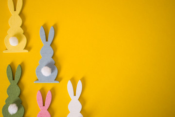 Easter bunnies on yellow background. Easter holiday background concept