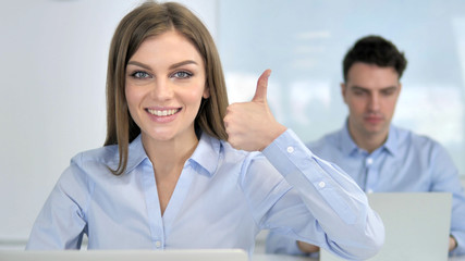 Thumbs Up by Young Businesswoman in Office