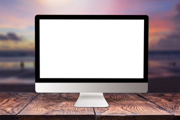 Computer mockup screen on wooden table against sea background.