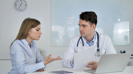 Fototapeta premium Doctor Telling about Disease to Patient, Medical Report
