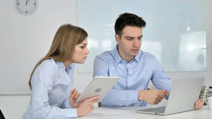 Two Young Business Colleagues Working on Laptop