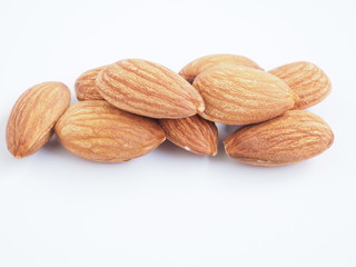 A pile of almonds seed isolated on a white background.  