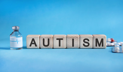 AUTISM - text on cubes. Drug in ambula, tablets in blisters to reduce disease symptoms