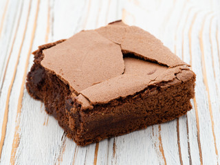 Chocolate Brownie on wooden table, close up