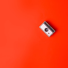 Old vintage Photo Camera on a orange Background