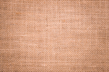Rough hessian background with flecks of varying colors of beige and brown. with copy space. office desk concept, Hessian sackcloth burlap woven texture background.