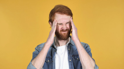 Redhead Man with Headache Isolated on Yellow Background