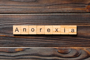 anorexia word written on wood block. anorexia text on table, concept