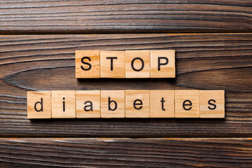 Stop diabetes word written on wood block. Stop diabetes text on wooden table for your desing, Top view concept