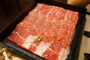 Close up tray of sliced pork and beef meat prepared for Shabu Shabu, Japanese hot pot