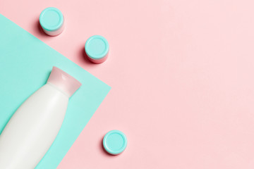Group of plastic bodycare bottle Flat lay composition with cosmetic products on pink and blue background empty space for you design. Set of White Cosmetic containers, top view with copy space