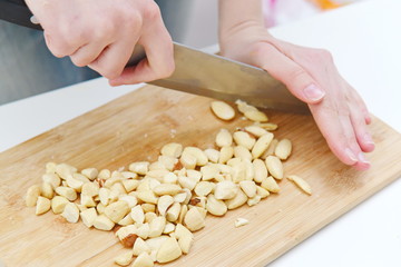 peeled nuts chopped with a knife on a board