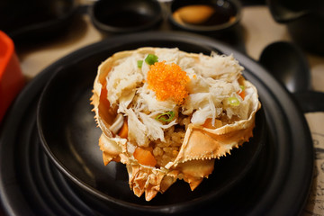 Close up Kani Miso Korasho, Grilled Japanese crab and garlic rice on shell