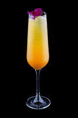 Exquisite cold cocktail with champagne and orange juice on a dark background