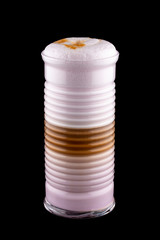 Hot coffee drink on a black background. Latte with milk and colorful additives