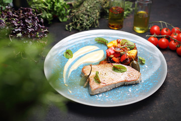Fish pan with vegetable ratatouille. A plate with an appetizing dish. Application suggestion. Culinary photography, food stylization.