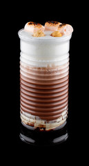Hot coffee drink on a black background. Latte with milk and colorful additives, with marshmallows.