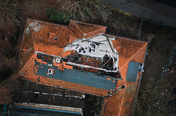 roof of house damaged by heavy hurricane tornado storm
