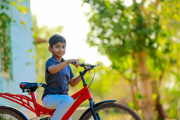 Naklejka premium Indian / Asian little boy enjoy cycle riding