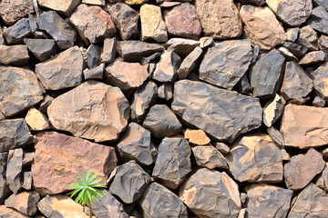 Texture of a red orange granite stone wall for background