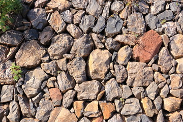 Texture of a red orange granite stone wall for background