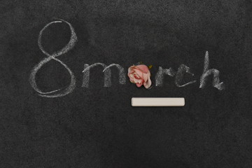 the phrase March 8 with a rose bud is written on the Board