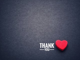 The words thank you and the red heart on the black paper background. - obrazy, fototapety, plakaty