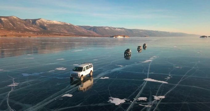 Extreme driving on the on frozen lake. Off-road vehicles in the winter. Baikal, Russia