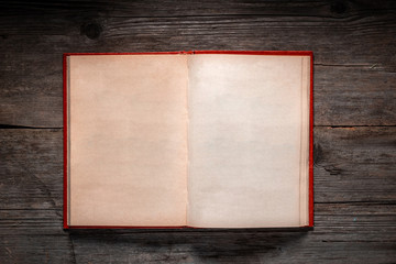 Vintage book, open, on old wooden table, with clipping path. Open Book blank on old wooden background. book with blank pages