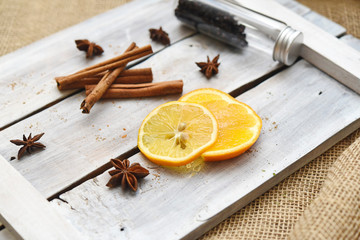 slices of orange and lemon on a wooden board with ingredients for desserts