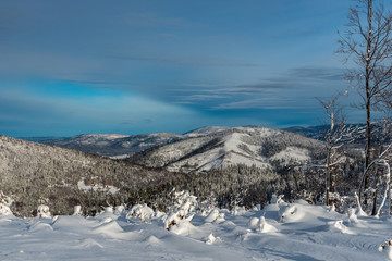 winter mountain scenery with blue sky and clouds