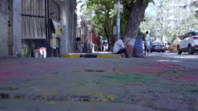 Pavement footpath in Mumbai India covered with colors after the festival of Holi