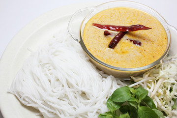Traditional Thai menu, rice noodles in fish curry sauce with vegetables (called Kanom Jeen Nam Ya in Thai) isolated on white background